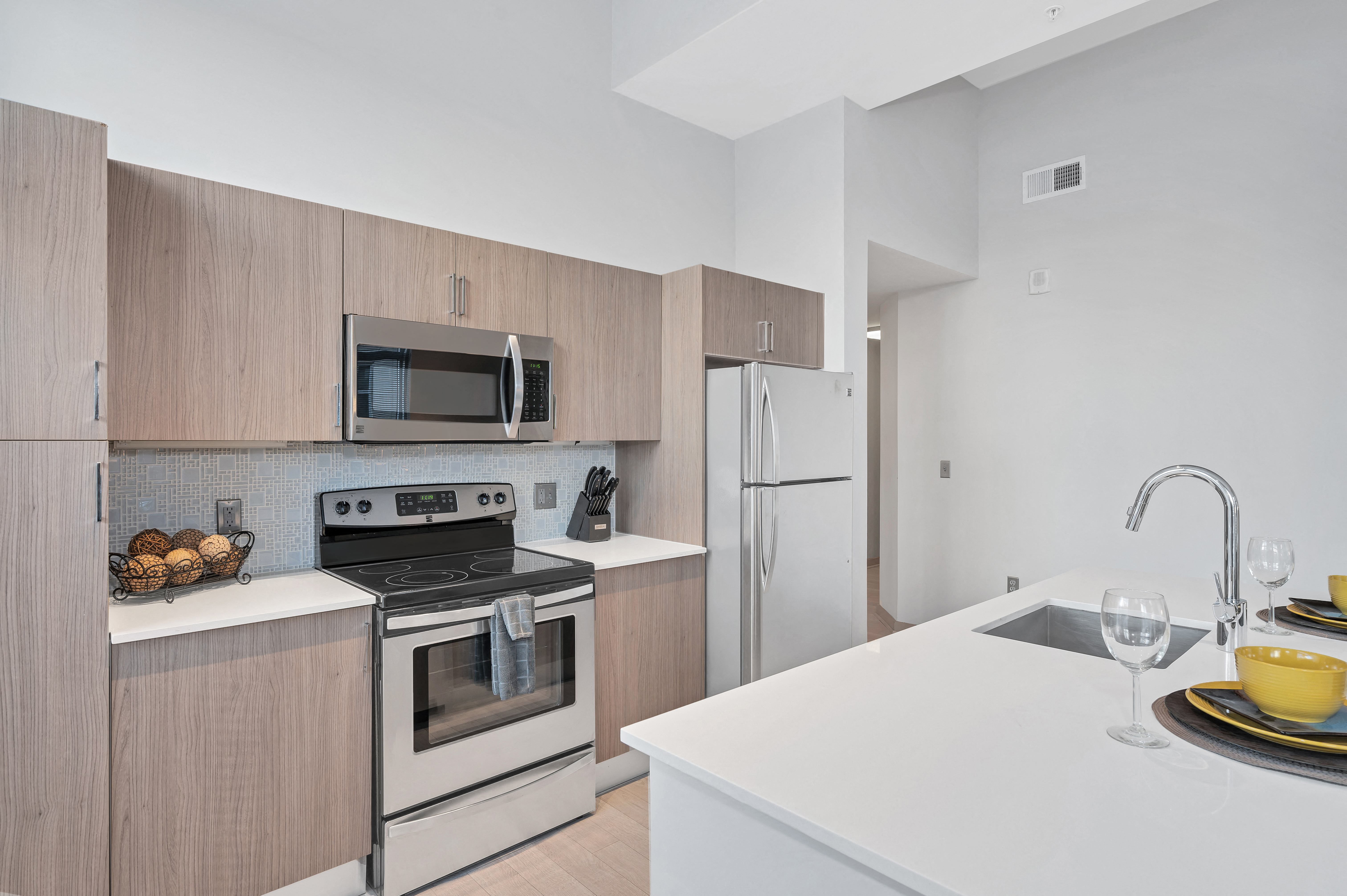 Gourmet designer kitchens with stainless steel appliances, track lighting, quartz countertops, and Italian kitchen cabinetry Gourmet designer kitchens with stainless steel appliances, track lighting, quartz countertops, and Italian kitchen cabinetry